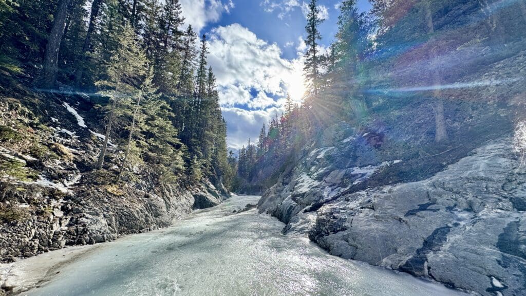 Great sunshine on the frozen Icewalk in Grotto Canyon, one of the best hikes in Kananaskis