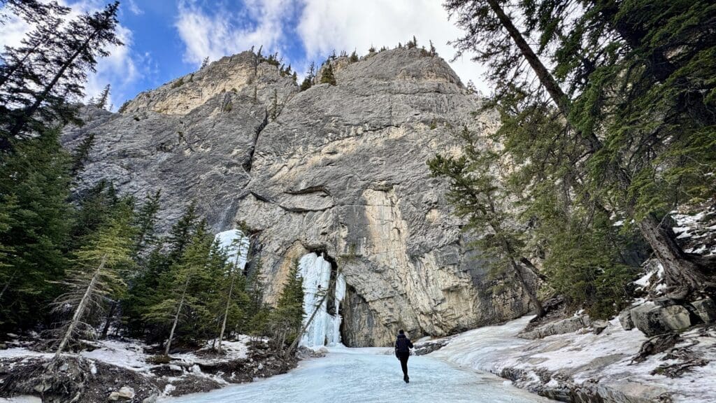 Arriving Grotto Canyon Ice Falls, one of the best hikes in Kananaskis, with tall mountain at the end of the icewalk