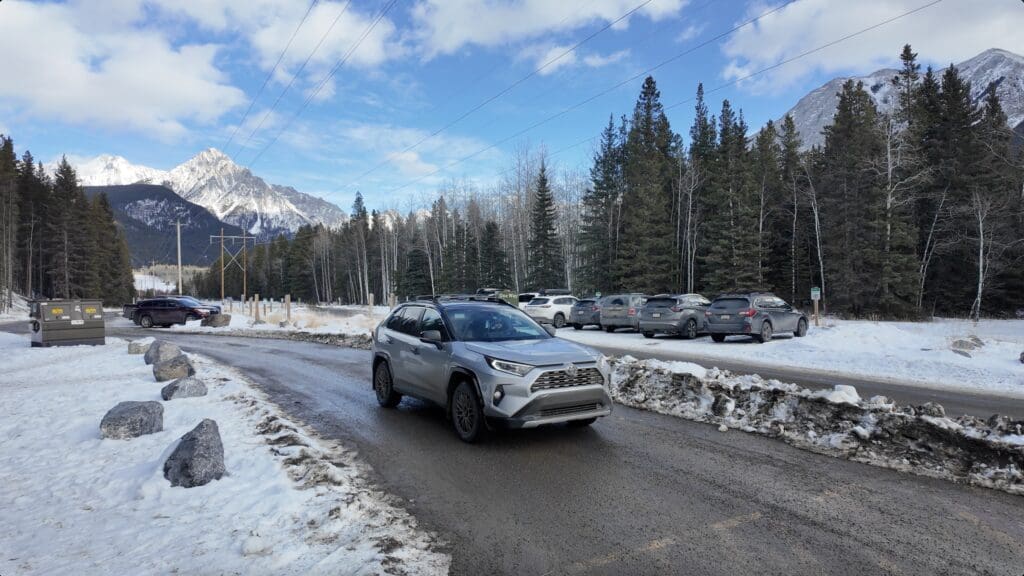 With some cars parking at the troll falls parking trailhead Kananaskis in winter