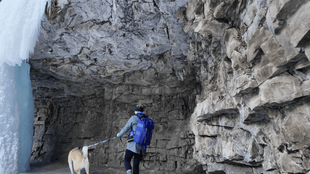 Walking along the cave behind Marmot Falls in Kananaskis