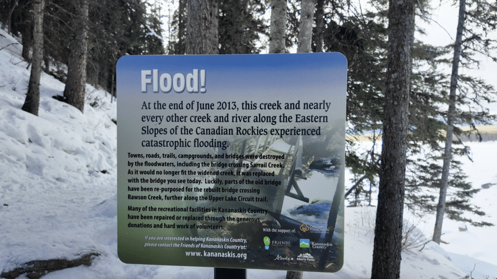 A sign introducing the flooding history of Canadian Rockies in 2013 and the reason of rebuilding the bridge