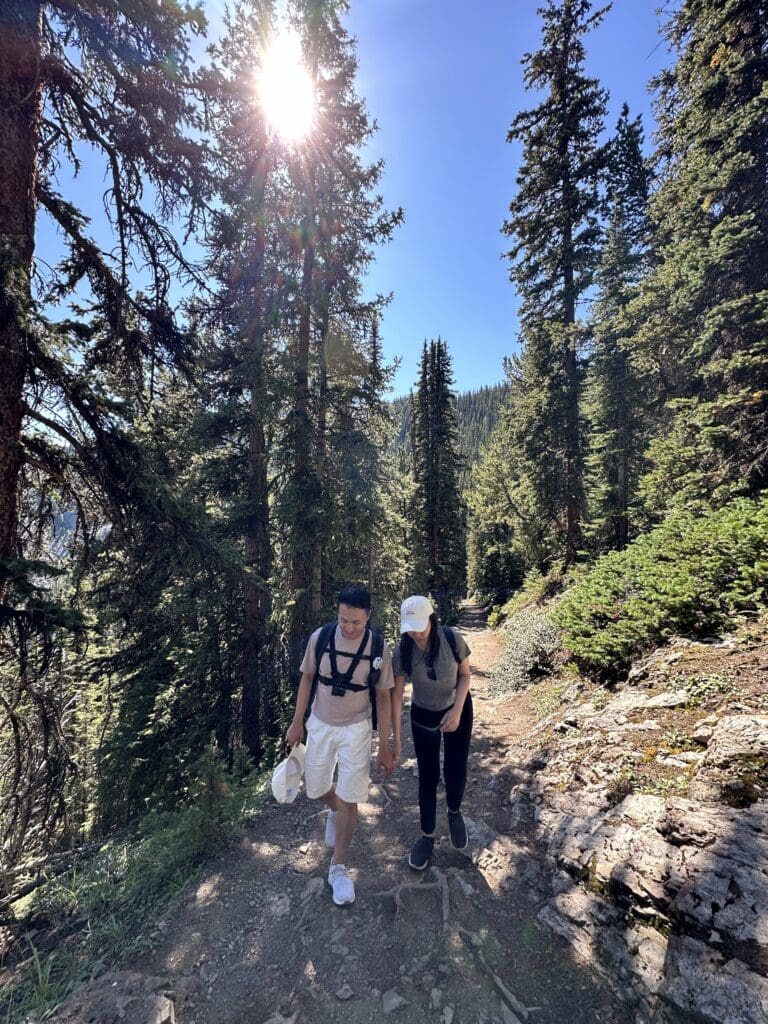 Evan and Michelle hiking up Sulphur Mountain in Banff National Park on a sunny day