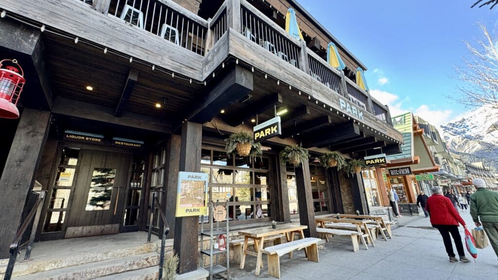 Park Distillery is a two-storey restaurant in Banff Town with some outdoor wooden tables and benches placed right outside the restaurant