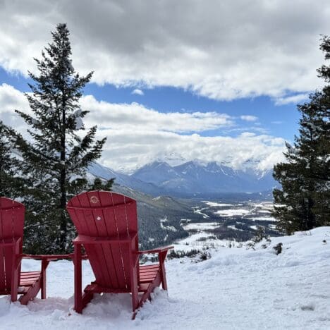 A pair of red chair placed by Parks Canada for being a scenic spot on Tunnel Mountain Summit in Banff National Park