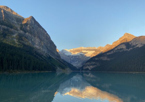 Beautiful sunrise at Lake Louise with calm water showing sky reflection