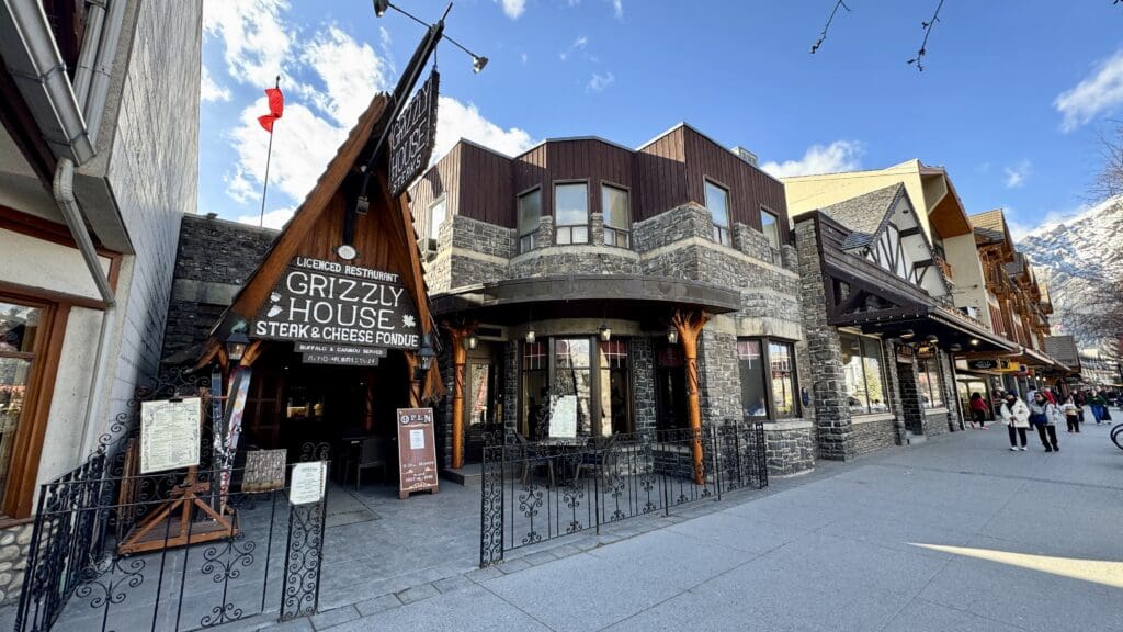 The Grizzly House is a specially designed restaurant located at Banff Avenue with metal fences surrounded