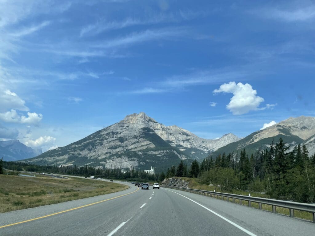 Trans Canada Highway on the Way to Banff Town with trees and mountain on the side