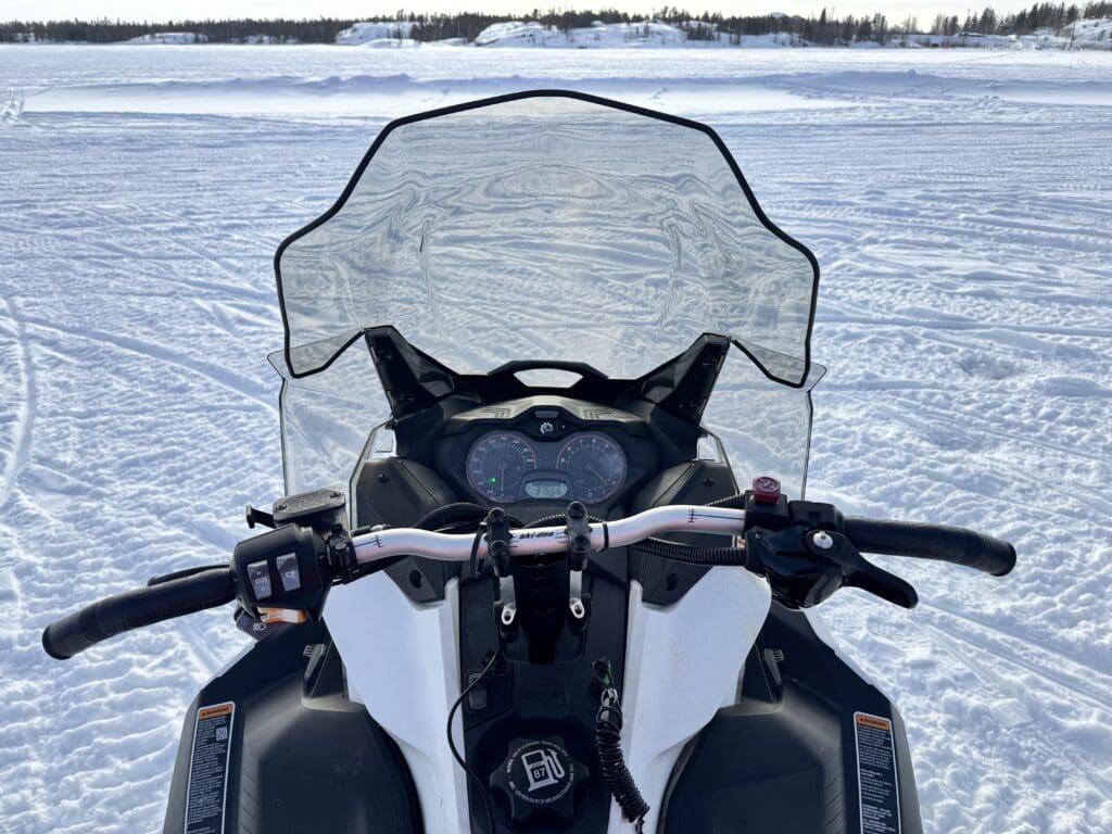 Waiting at a snowmobile on a snow-covered lake in Yellowknife