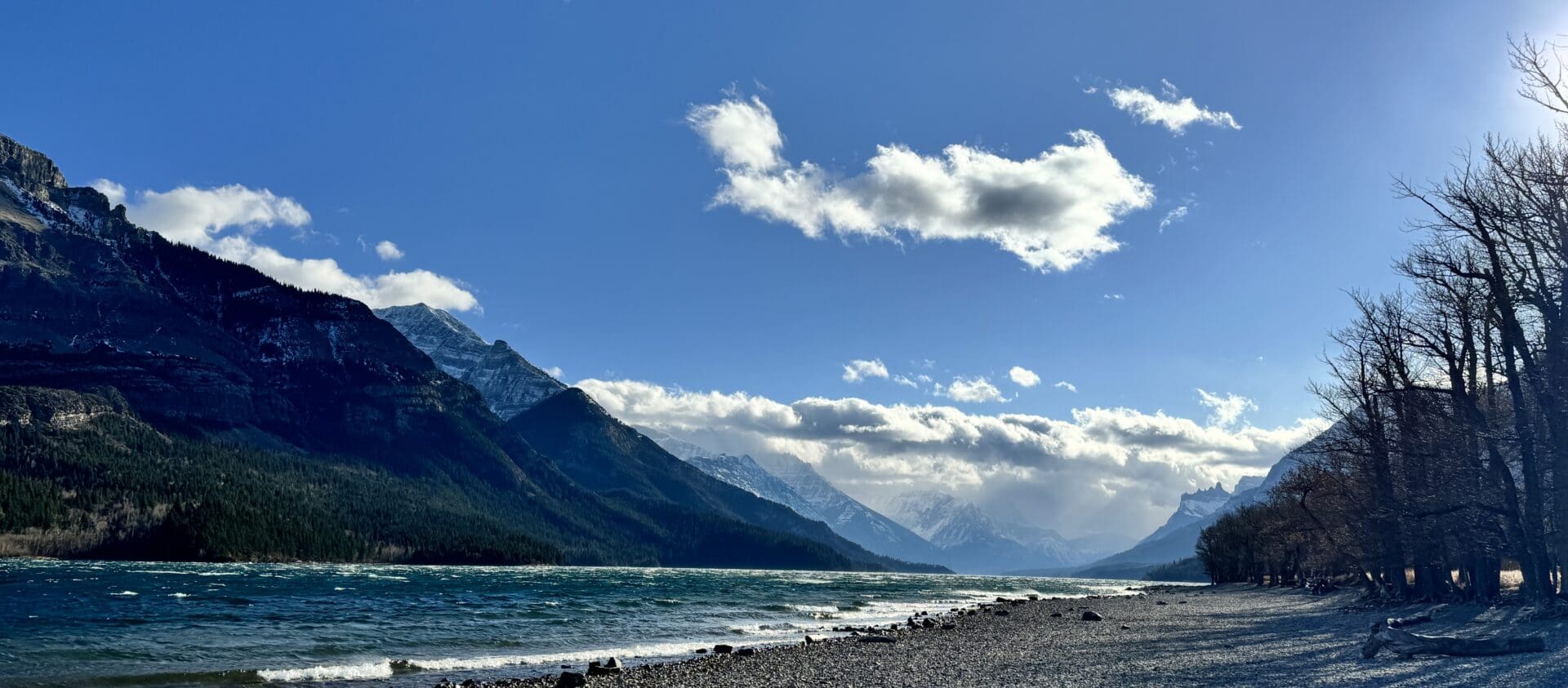 Sunny Day in Waterton Lake with layered mountains at the back